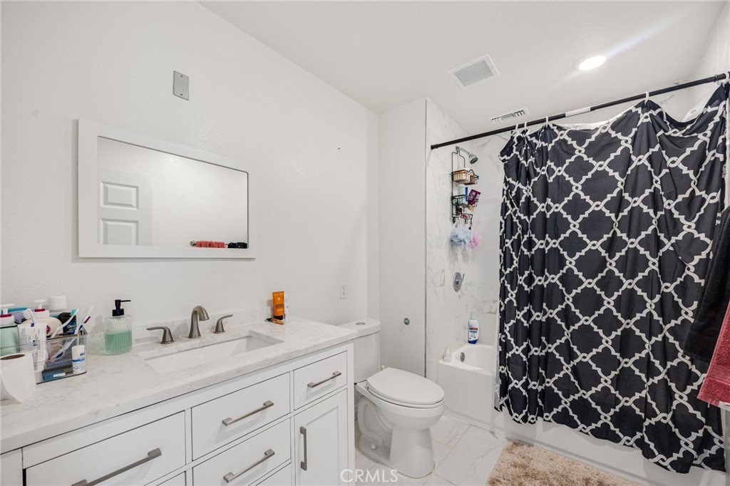 21192 Telegraph Road Riverside, CA 92507 - Photo 15 of 35 a bathroom with a granite countertop sink toilet and shower