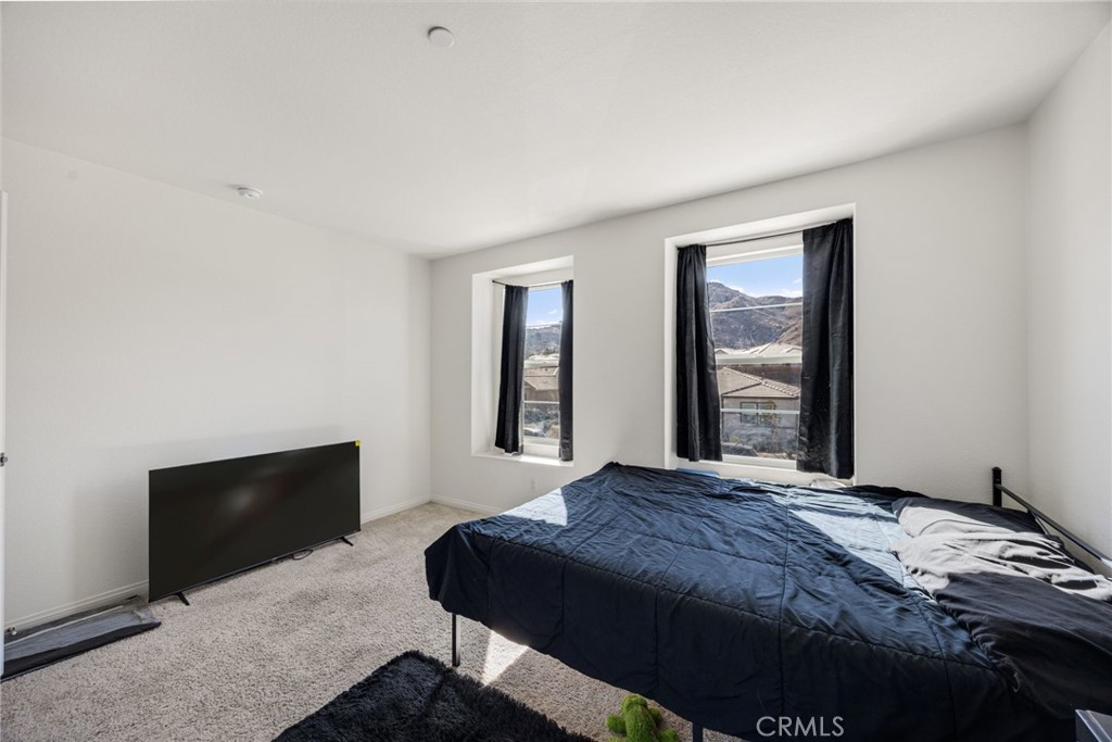 21192 Telegraph Road Riverside, CA 92507 - Photo 17 of 35 a bedroom with a bed and window