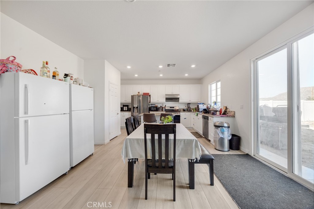 21192 Telegraph Road Riverside, CA 92507 - Photo 2 of 35 a view of a dining room with furniture a kitchen view and a refrigerator