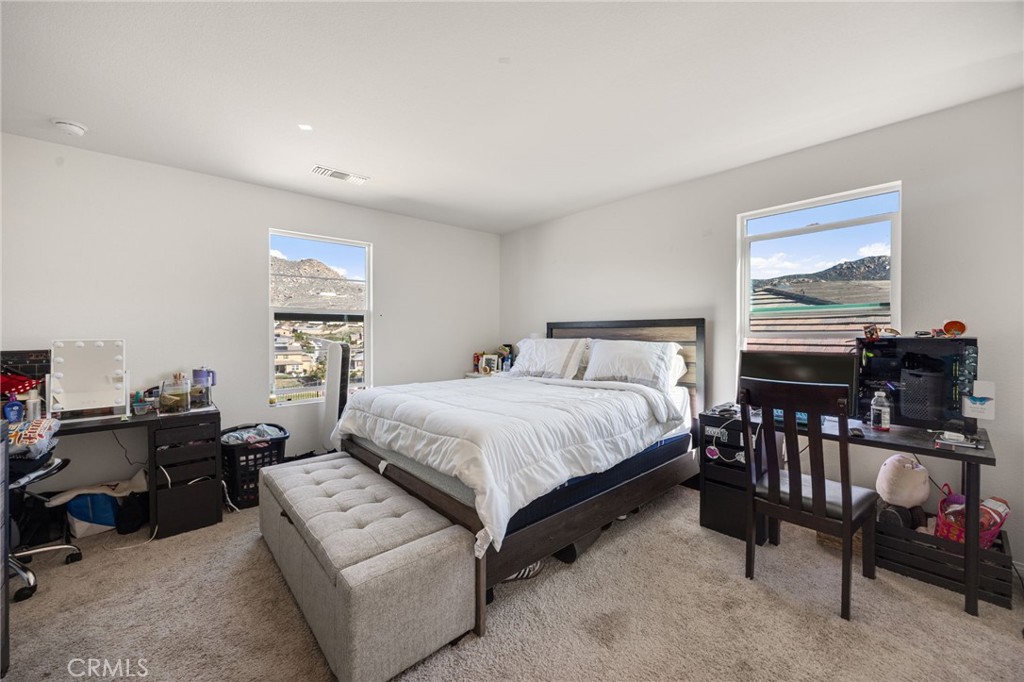 21192 Telegraph Road Riverside, CA 92507 - Photo 24 of 35 a spacious bedroom with a bed a couch and dresser