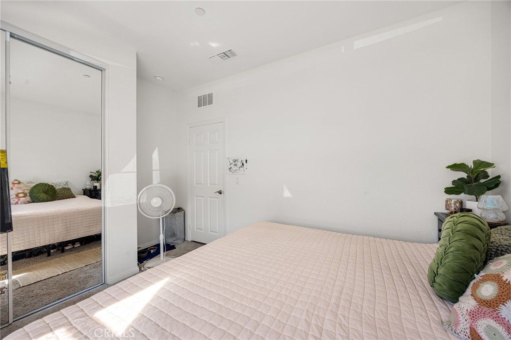 21192 Telegraph Road Riverside, CA 92507 - Photo 27 of 35 a bedroom with a bed and a potted plant
