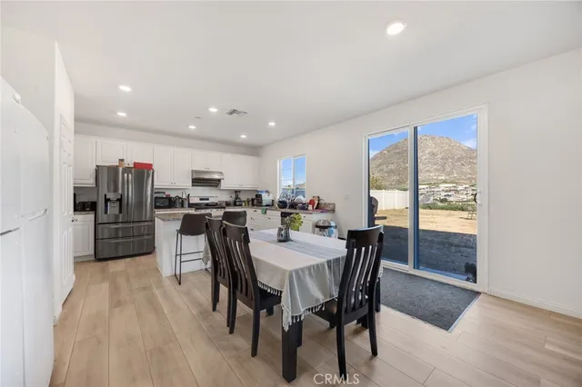 a dining room with furniture and kitchen view