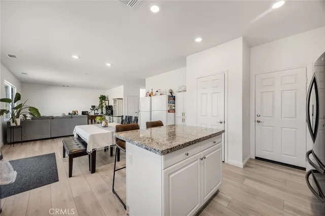 a kitchen with stainless steel appliances granite countertop a stove and a refrigerator