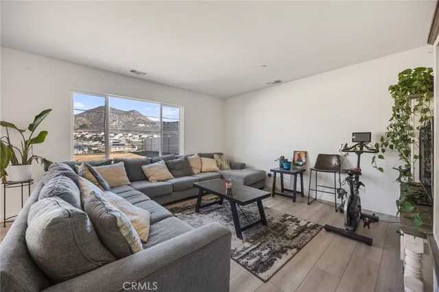 a living room with furniture and a floor to ceiling window