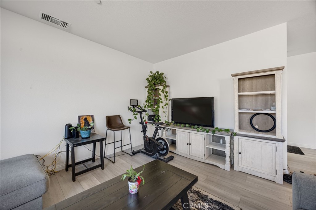 21192 Telegraph Road Riverside, CA 92507 - Photo 8 of 35 a living room with furniture and a flat screen tv