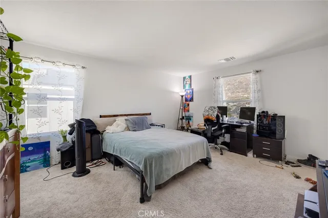 a bedroom with a bed and a desk