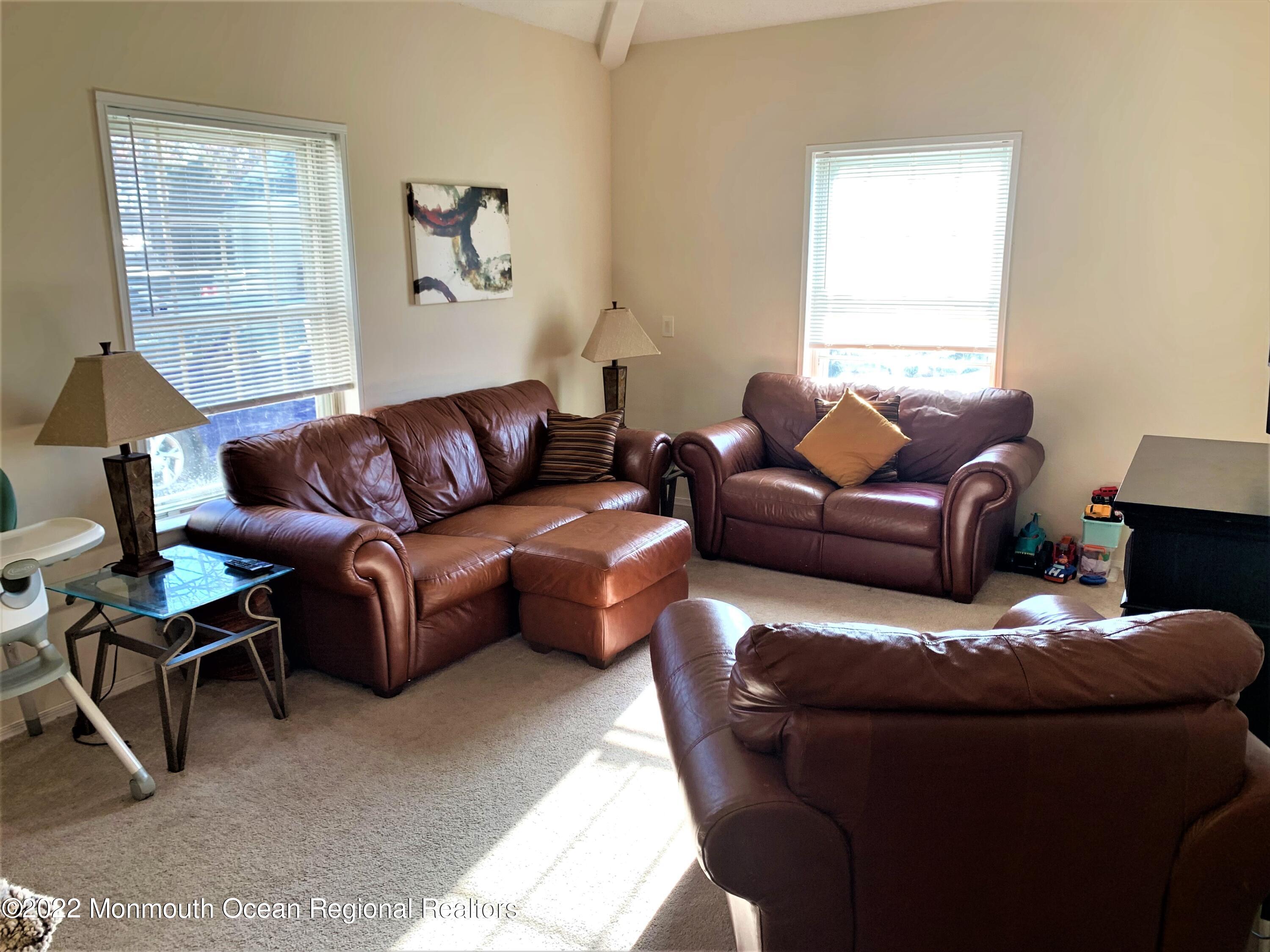 18 Sutton Drive, Unit 301 Brick, NJ 08724 - Photo 11 of 16 a living room with furniture and a window