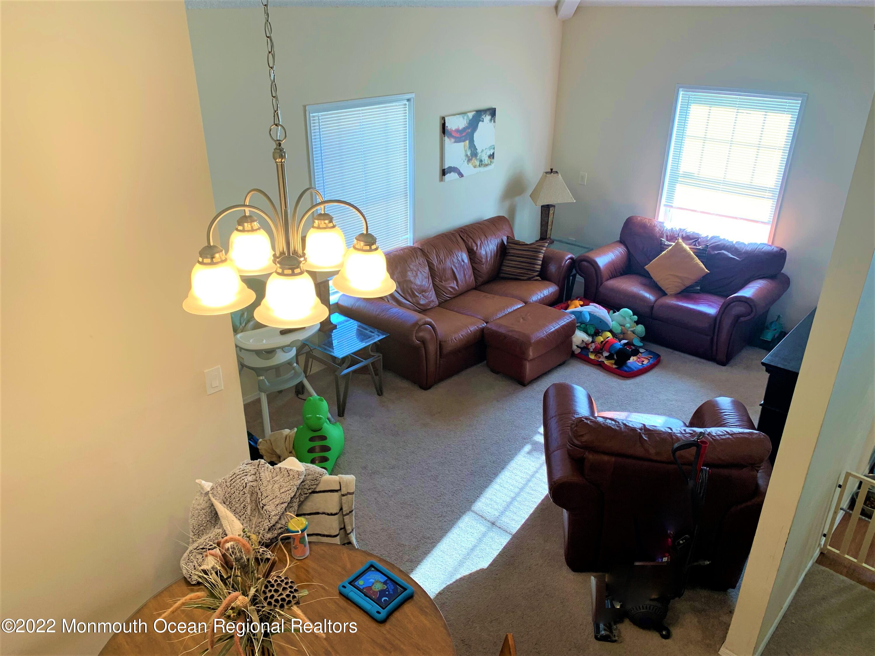 18 Sutton Drive, Unit 301 Brick, NJ 08724 - Photo 12 of 16 a living room with furniture and a window