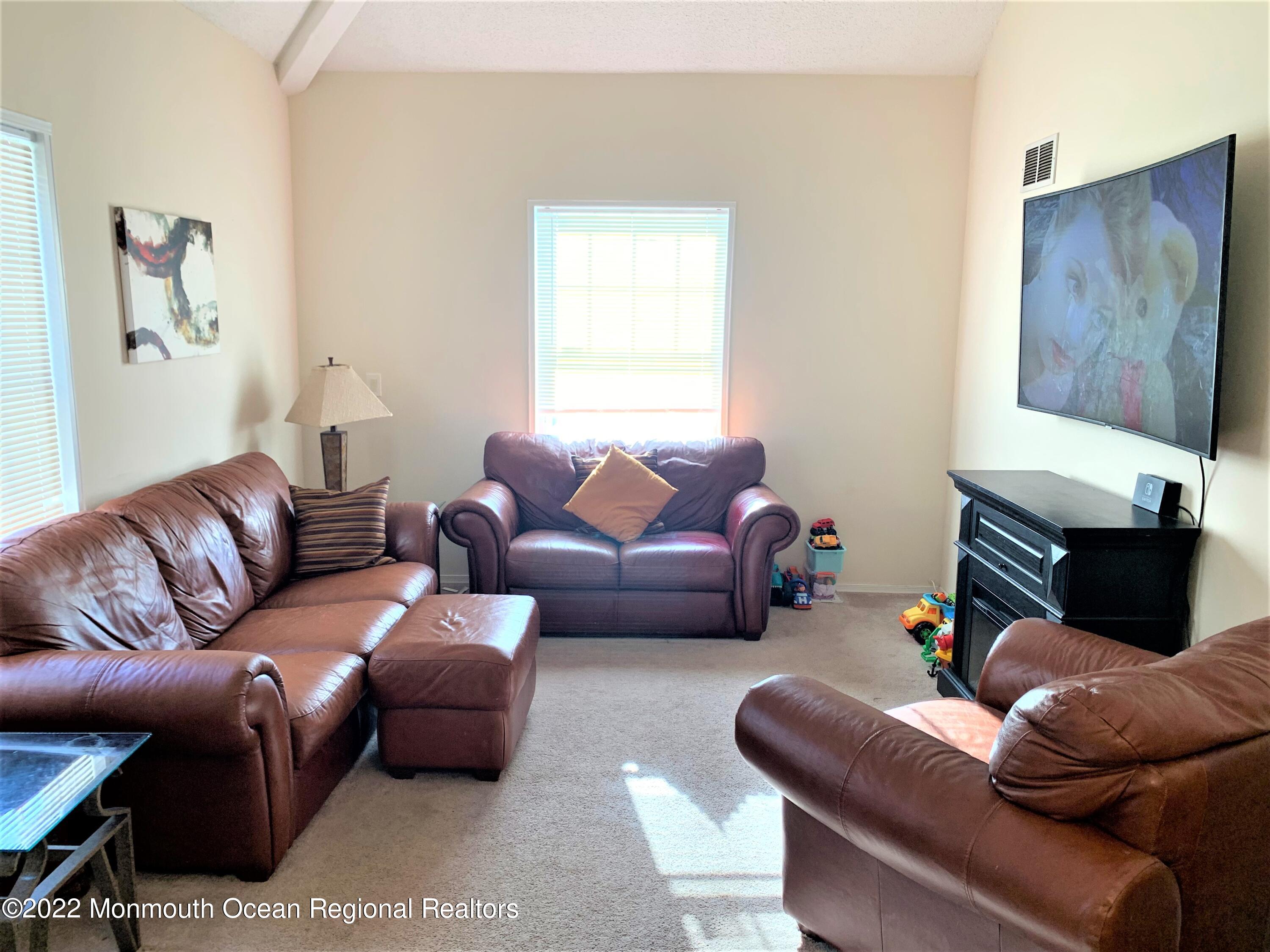 18 Sutton Drive, Unit 301 Brick, NJ 08724 - Photo 2 of 16 a living room with furniture and a couch