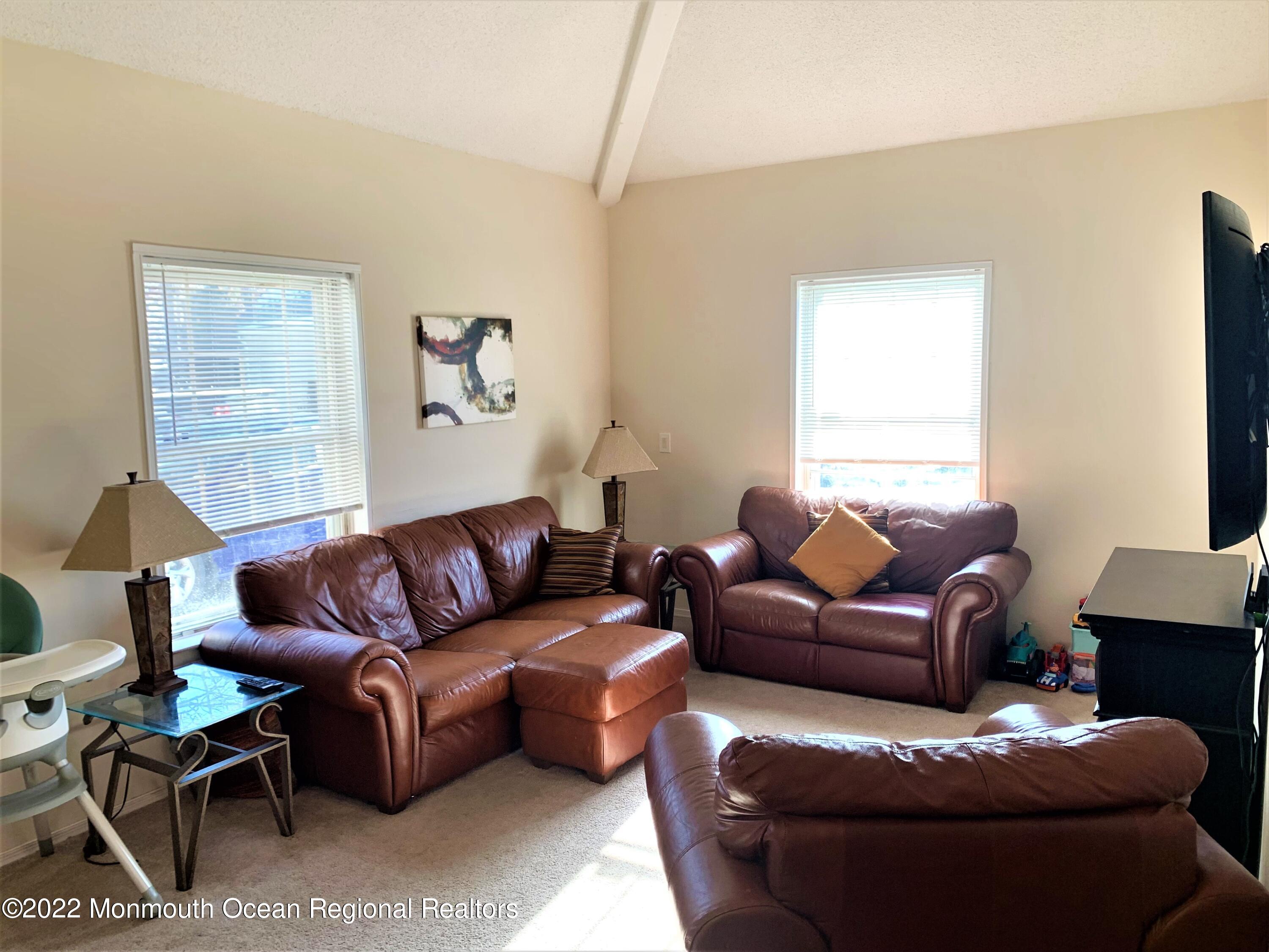 18 Sutton Drive, Unit 301 Brick, NJ 08724 - Photo 3 of 16 a living room with furniture and a window