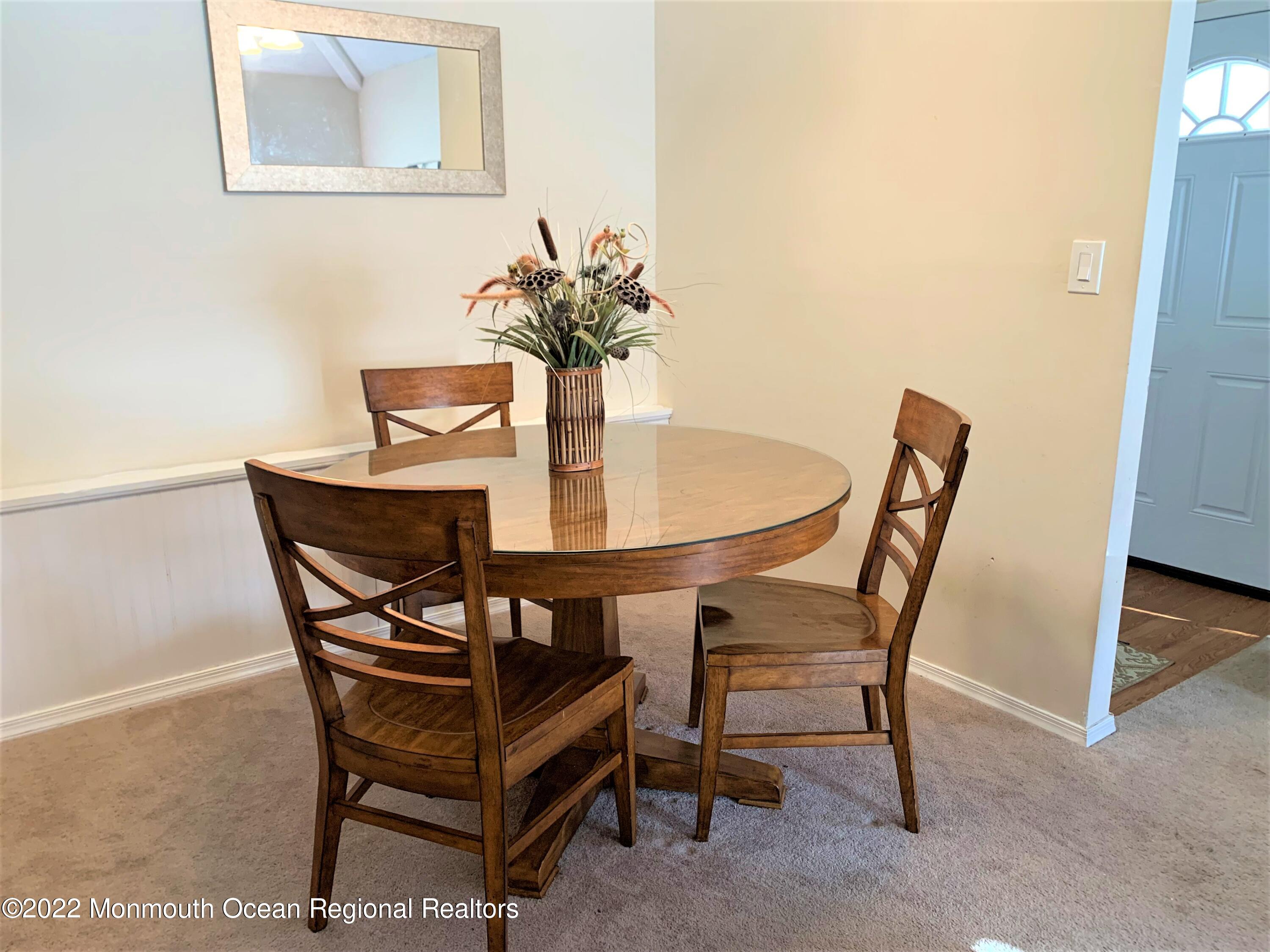 18 Sutton Drive, Unit 301 Brick, NJ 08724 - Photo 4 of 16 a dining room with furniture and wooden floor