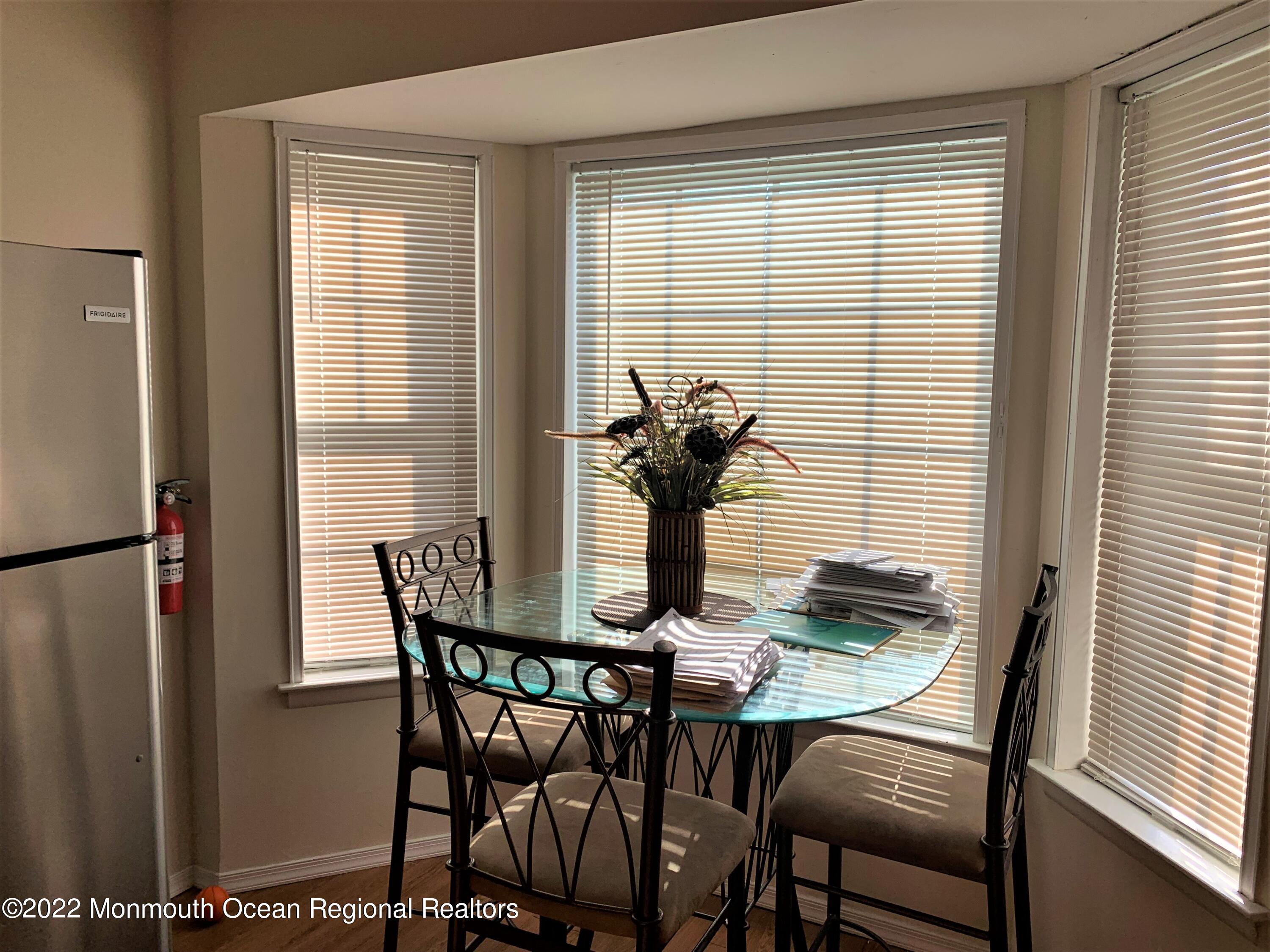 18 Sutton Drive, Unit 301 Brick, NJ 08724 - Photo 8 of 16 a view of a dining room with furniture and a window