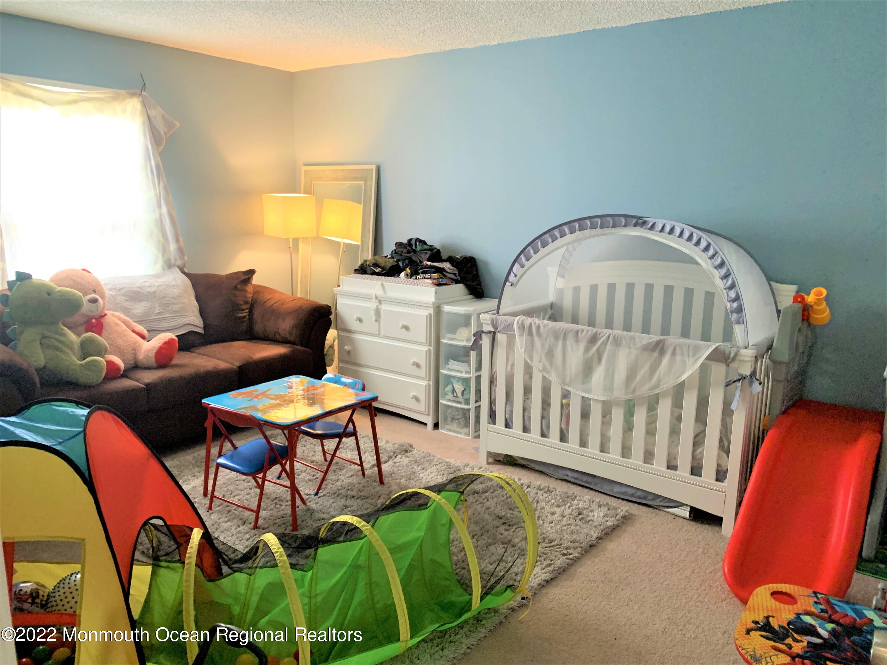 18 Sutton Drive, Unit 301 Brick, NJ 08724 - Photo 9 of 16 a living room with furniture fireplace and a window