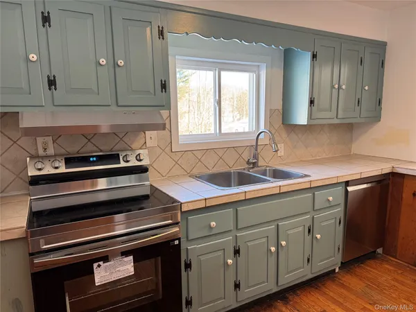 a kitchen with sink and cabinets