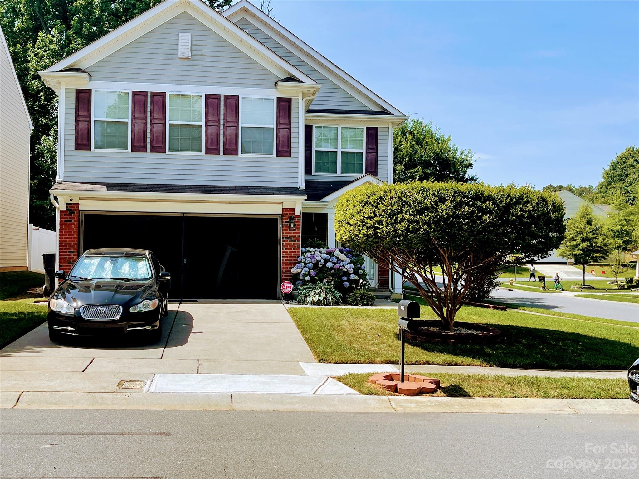 1002 Mearn Road, Unit 98 Charlotte, NC 28216 - Photo 1 of 9 a house with garden in front of it