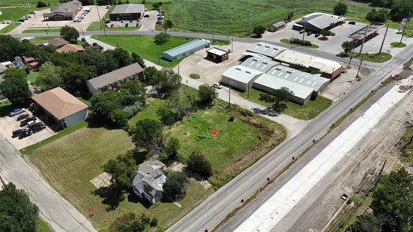 a aerial view of a house with a garden and lake view