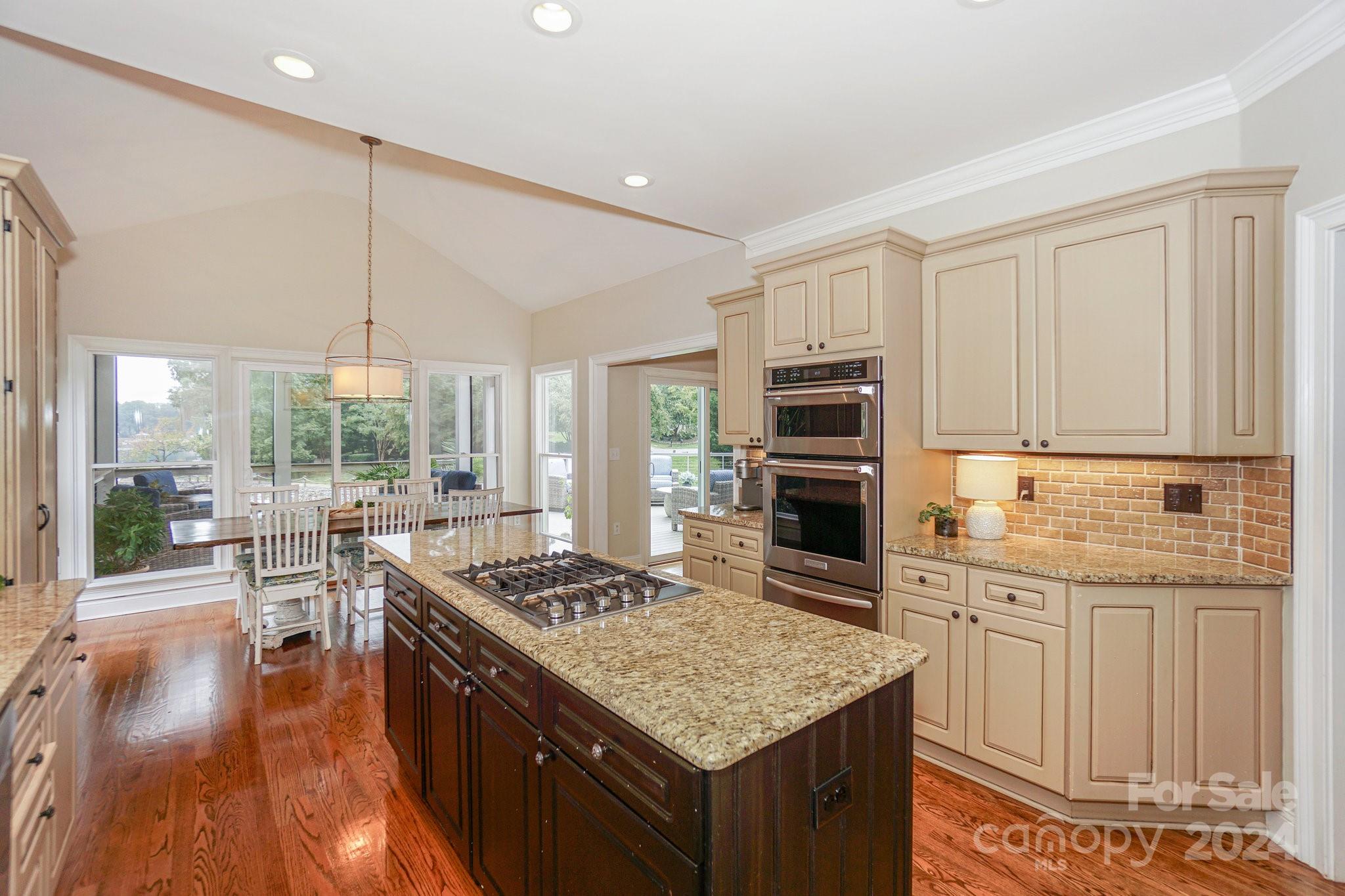 21910 Satilla Drive Cornelius, NC 28031 - Photo 16 of 47 a kitchen with stainless steel appliances granite countertop a stove oven and a refrigerator with cabinets