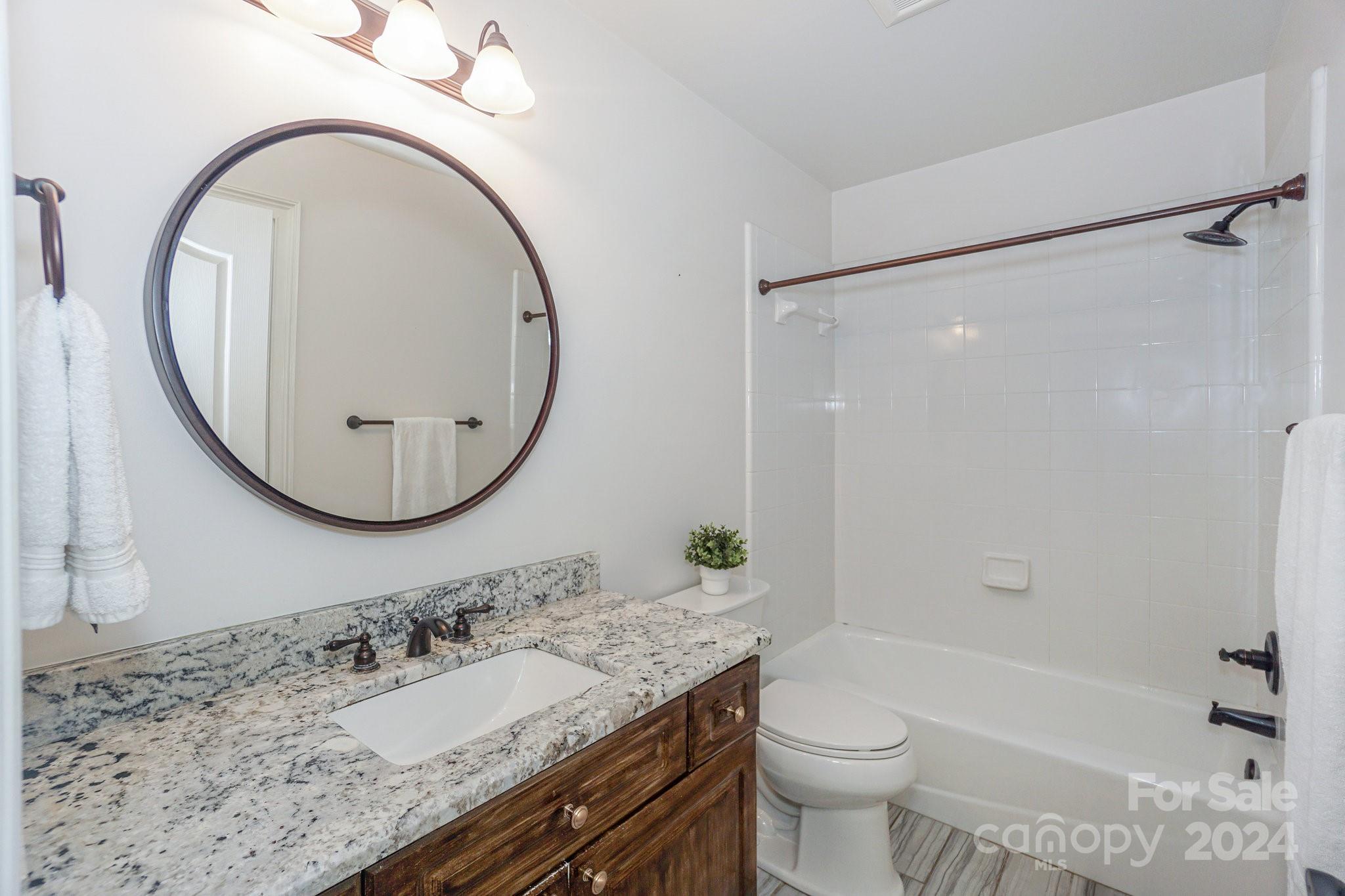 21910 Satilla Drive Cornelius, NC 28031 - Photo 33 of 47 a bathroom with a granite countertop sink mirror vanity and a toilet