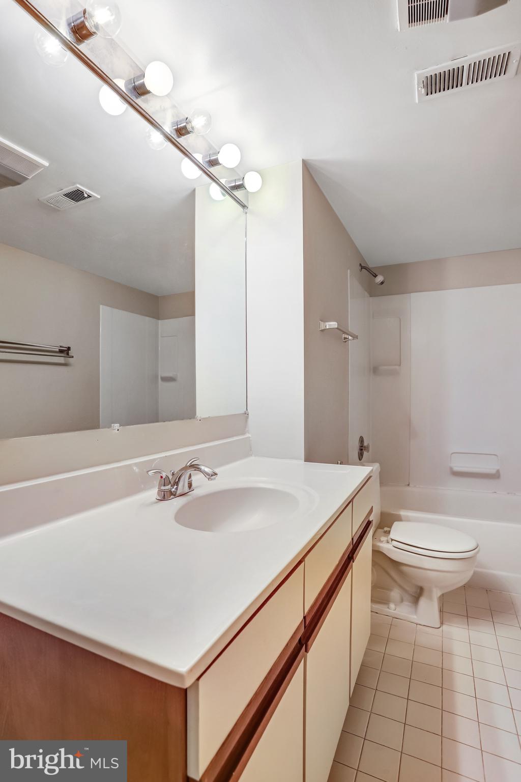 1953 Lakeport Way Reston, VA 20191 - Photo 44 of 60 a bathroom with a sink a toilet and a mirror