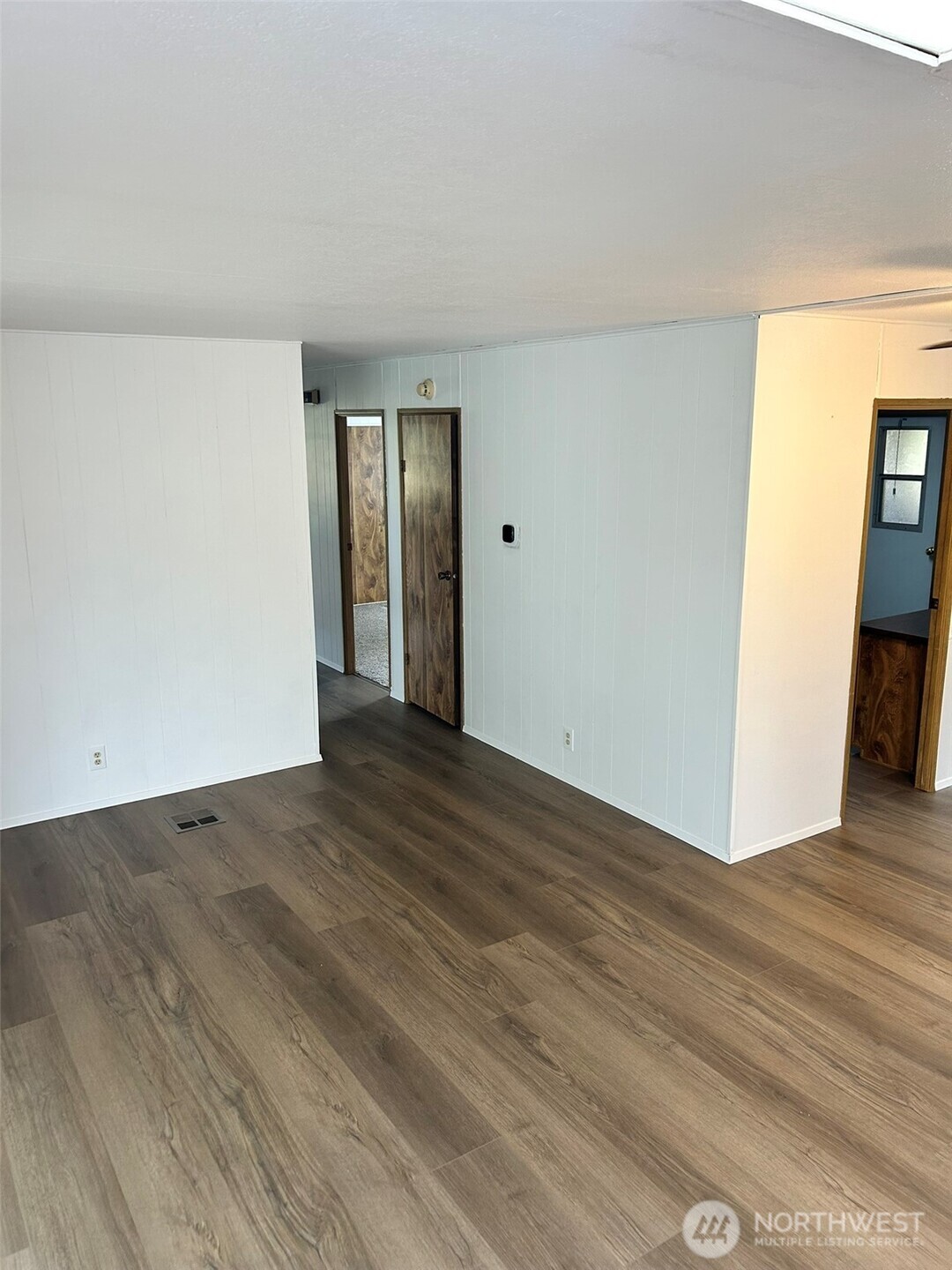 791 Elliot Court Sequim, WA 98382 - Photo 15 of 37 a view of an empty room with wooden floor