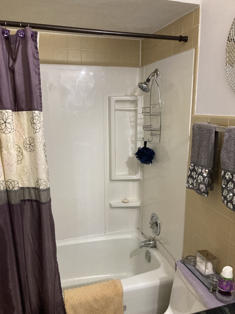 903 Elder Road, Unit 2 Homewood, IL 60430 - Photo 6 of 10 a bathroom with a shower curtain and a bathtub