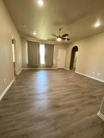 a view of a room with wooden floor