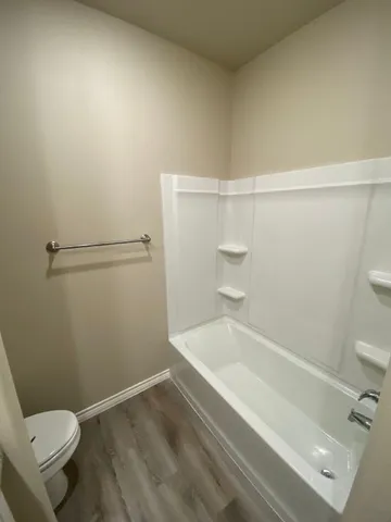 a bathroom with a bathtub and toilet