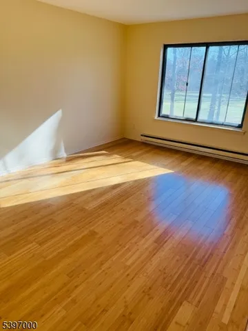 a view of a room with wooden floor