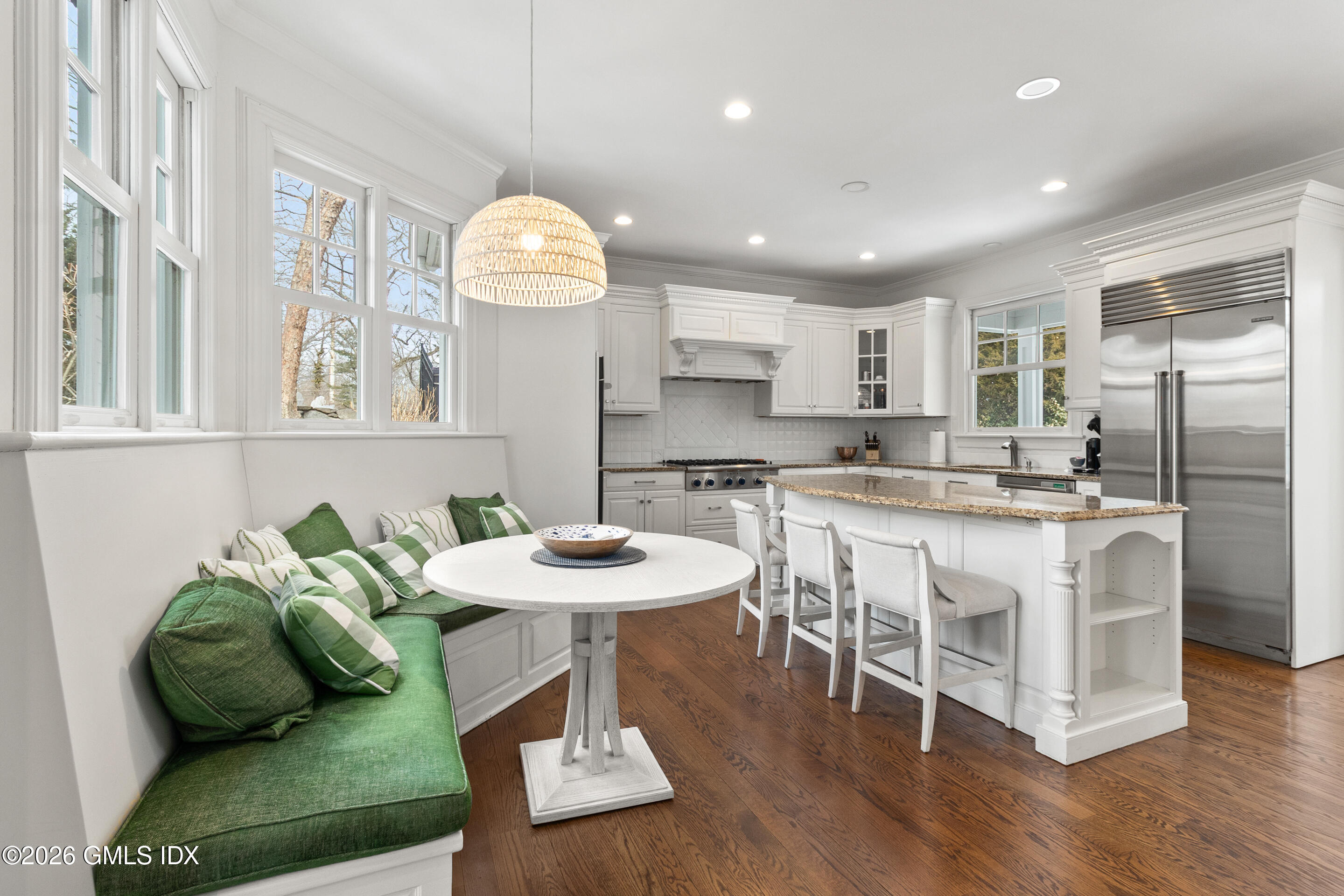 29 Weston Hill Road Riverside, CT 06878 - Photo 10 of 23 a kitchen with stainless steel appliances kitchen island granite countertop a table and chairs in it