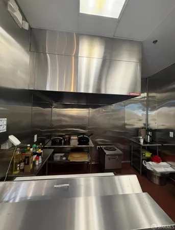 a kitchen with sink a stove and cabinets