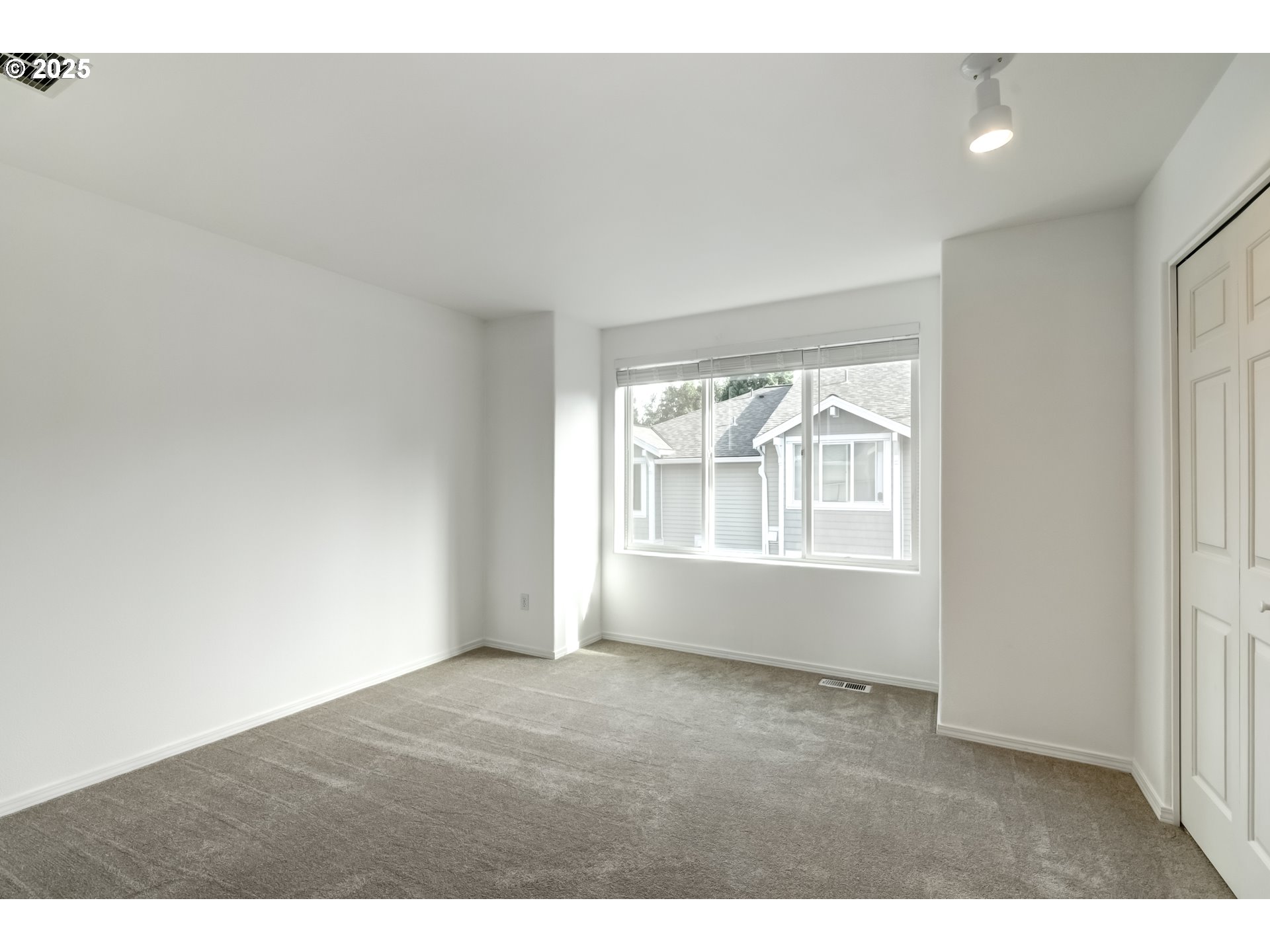16080 Southwest Audubon Street, Unit 103 Beaverton, OR 97003 - Photo 15 of 24 a view of an empty room with a window