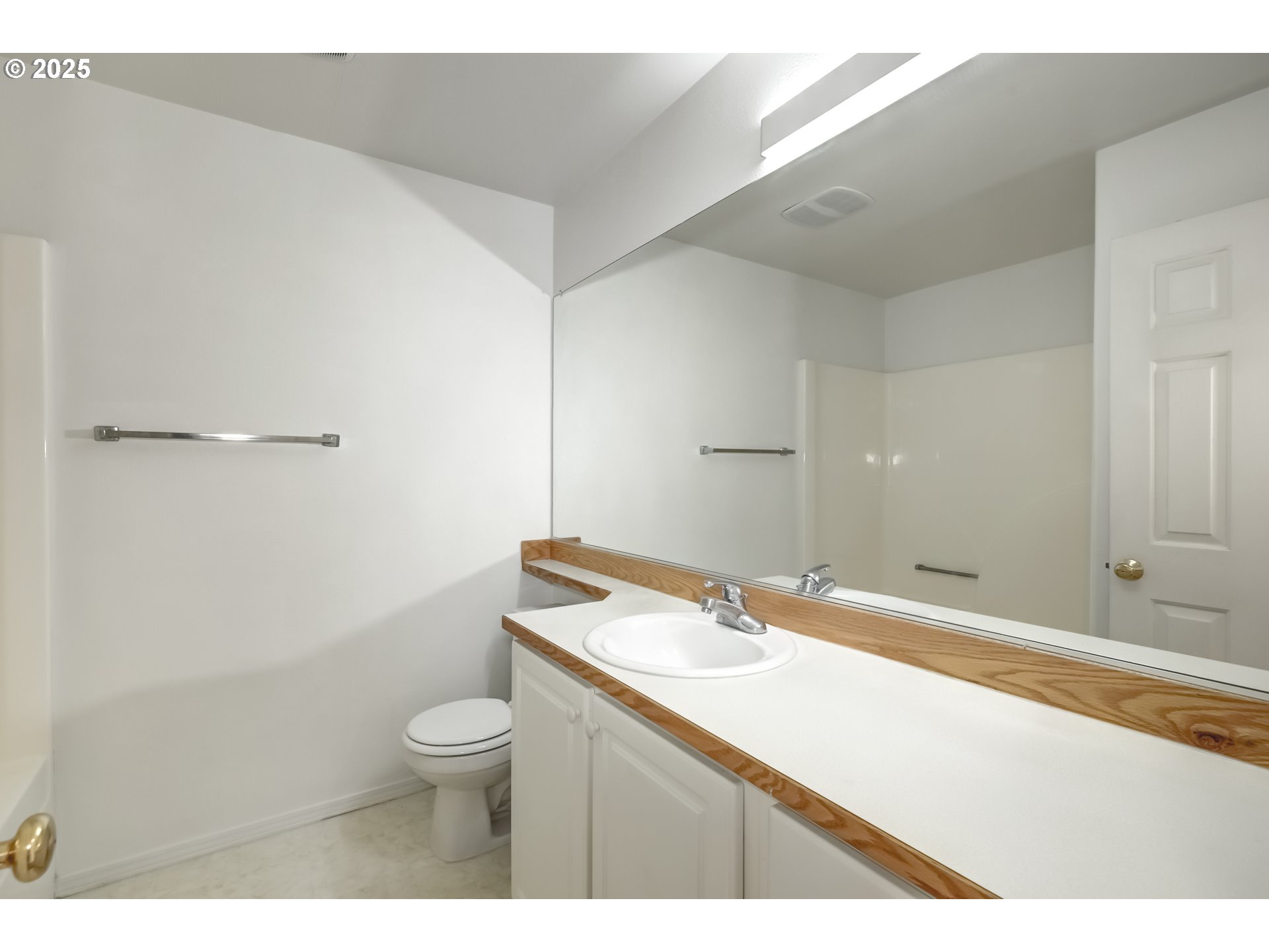 16080 Southwest Audubon Street, Unit 103 Beaverton, OR 97003 - Photo 17 of 24 a bathroom with a granite countertop sink a toilet and a mirror
