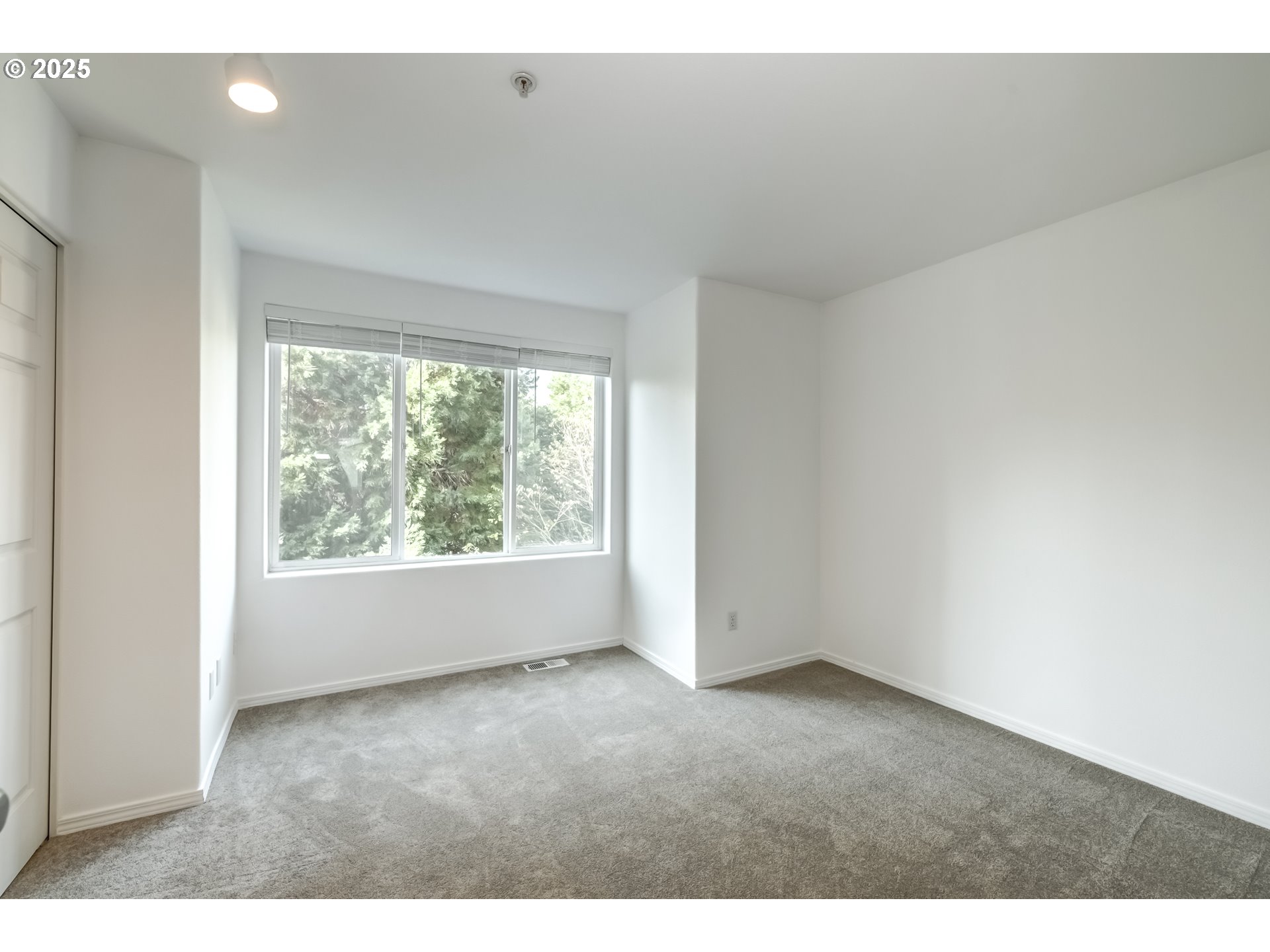 16080 Southwest Audubon Street, Unit 103 Beaverton, OR 97003 - Photo 18 of 24 a view of an empty room with a window
