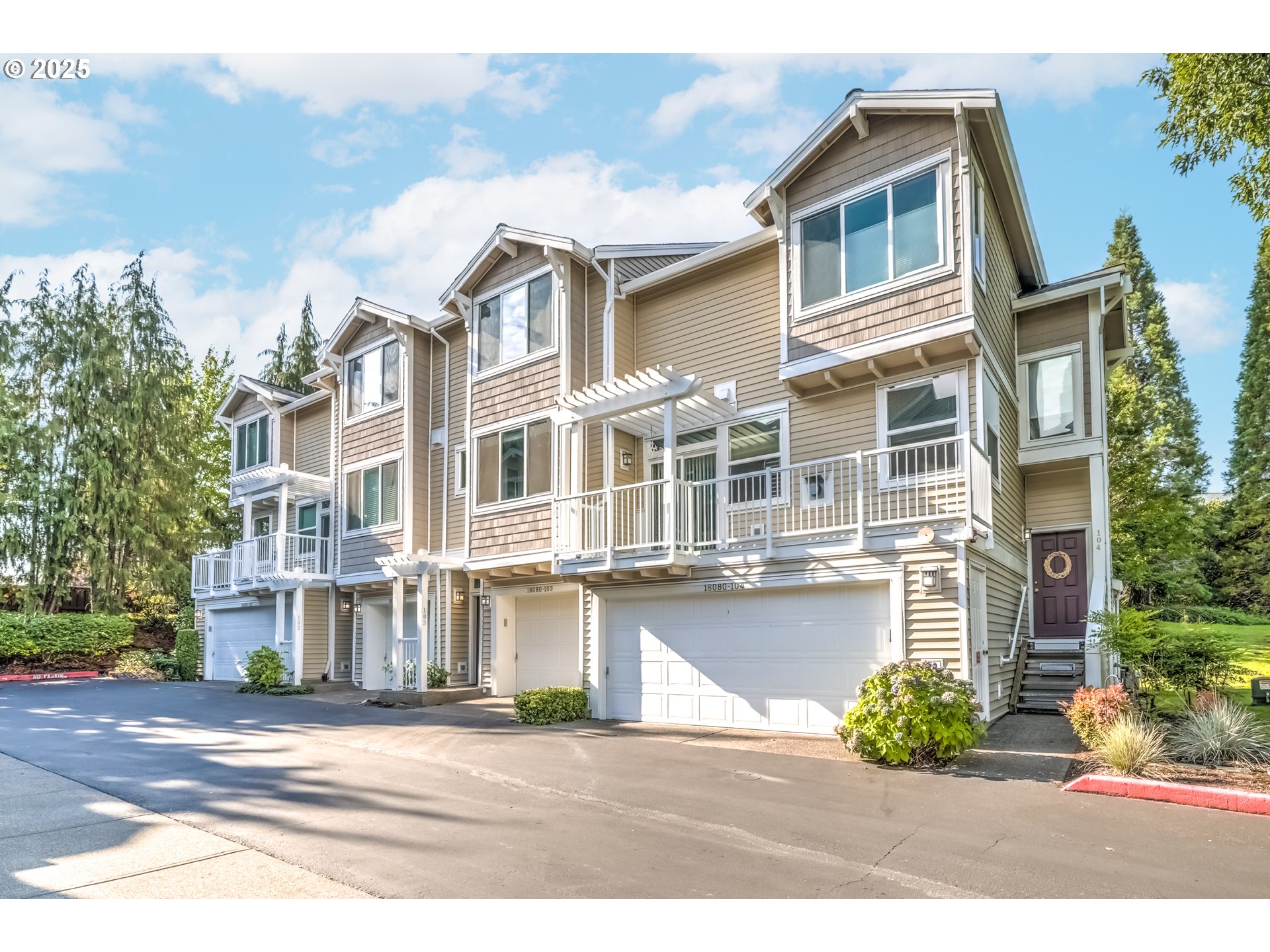 16080 Southwest Audubon Street, Unit 103 Beaverton, OR 97003 - Photo 2 of 24 a front view of residential houses with outdoor space and street view