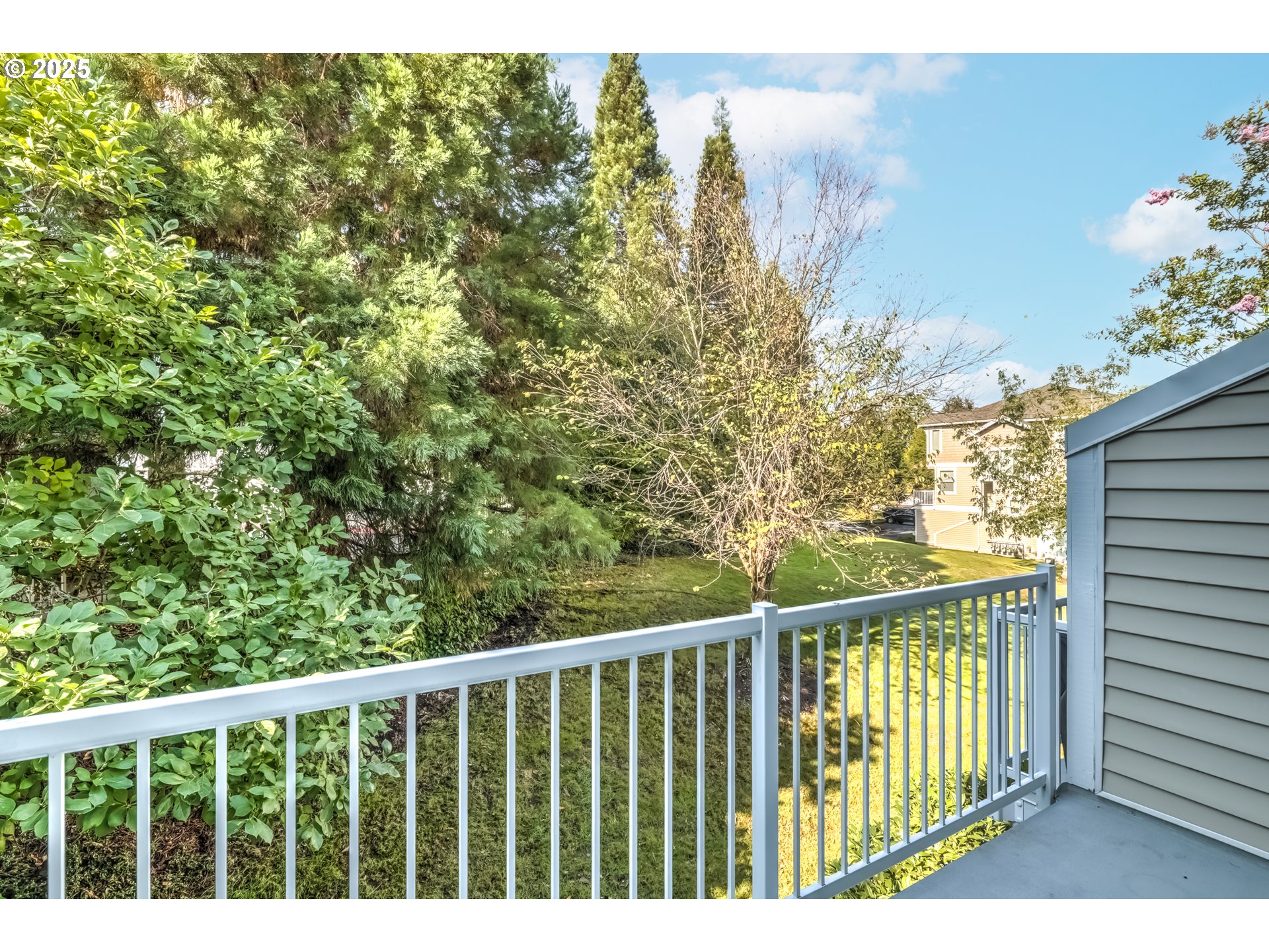 16080 Southwest Audubon Street, Unit 103 Beaverton, OR 97003 - Photo 21 of 24 a view of a balcony with wooden floor and fence