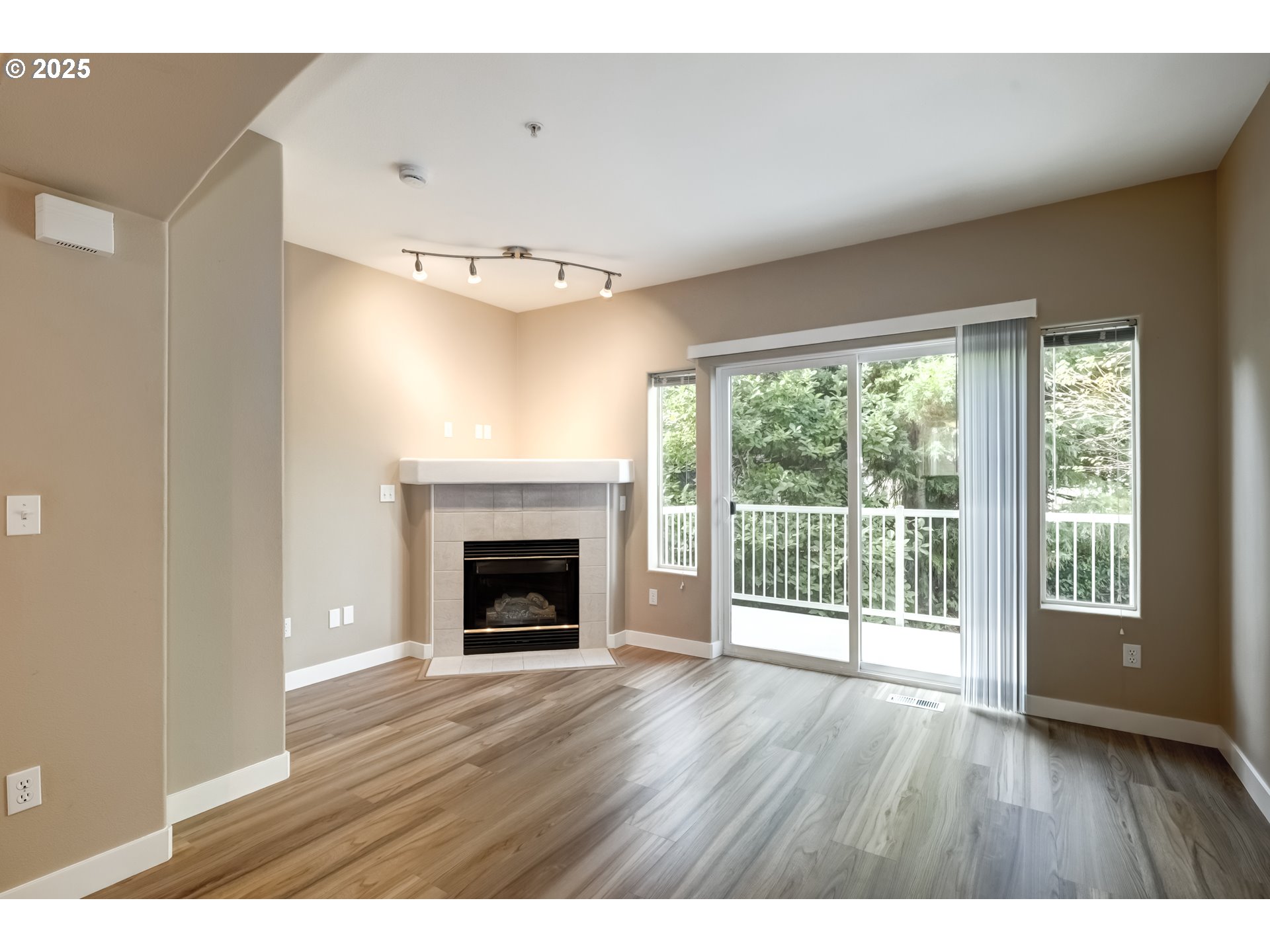 16080 Southwest Audubon Street, Unit 103 Beaverton, OR 97003 - Photo 8 of 24 a view of an empty room with wooden floor and a window