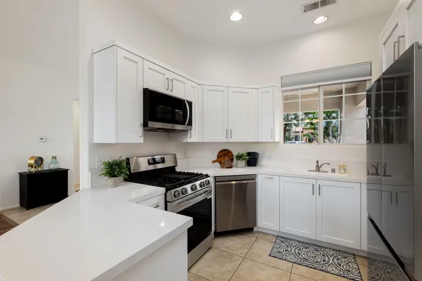 a kitchen with a sink a stove and cabinets