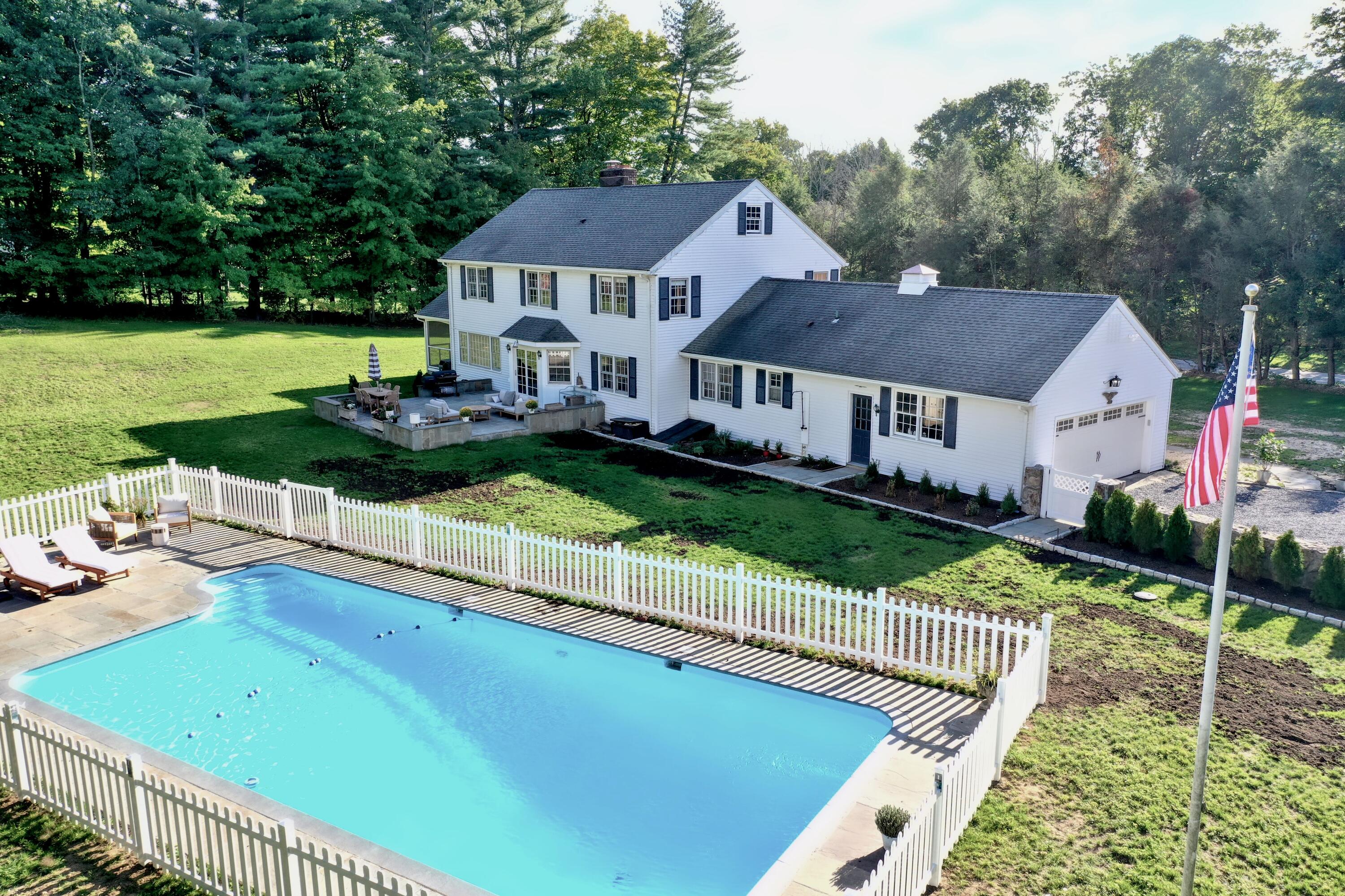 1293 Smith Ridge Road New Canaan, CT 06840 - Photo 3 of 34 a aerial view of a house with swimming pool and green space