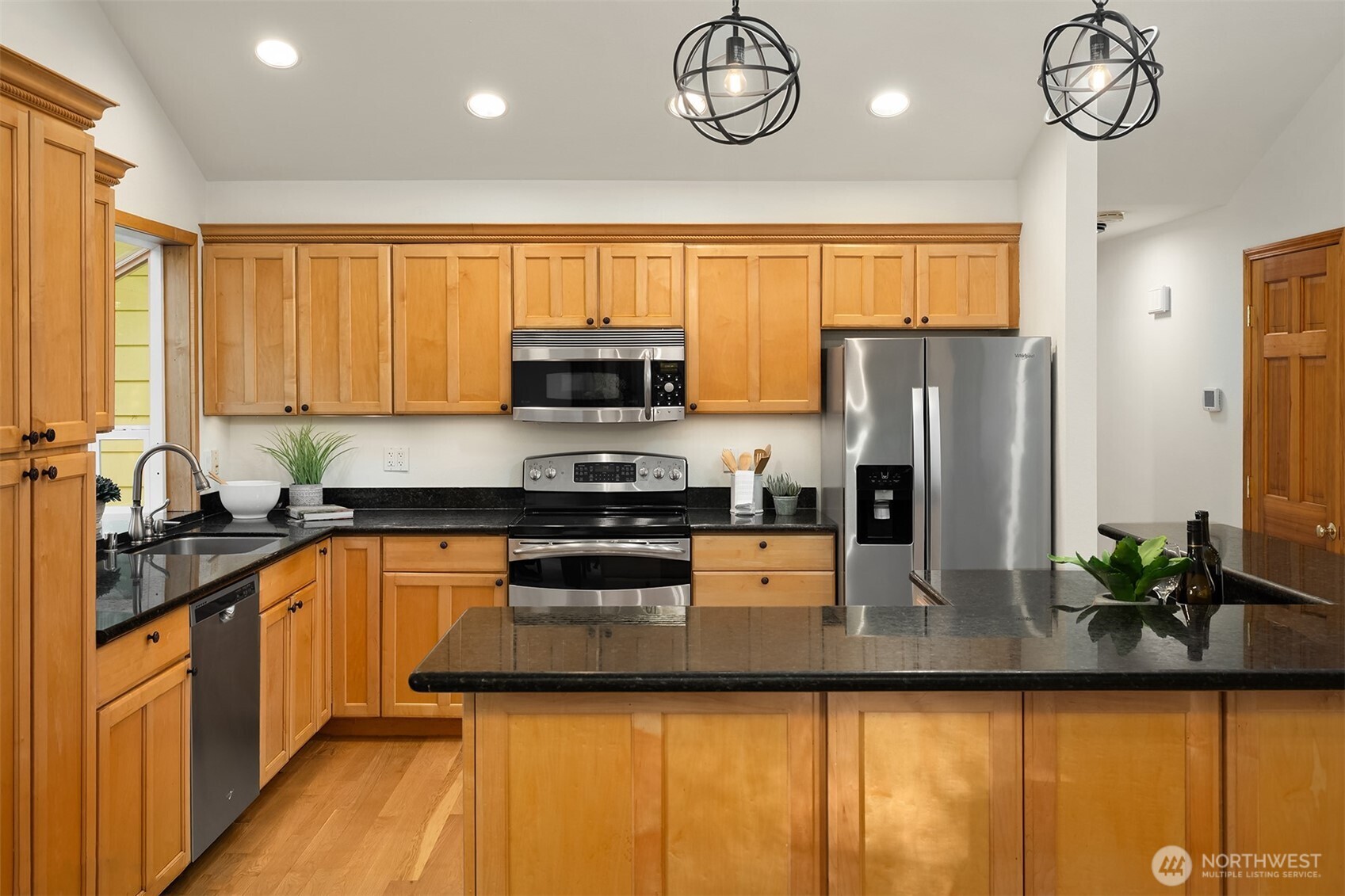 14410 48th Place West Edmonds, WA 98026 - Photo 8 of 24 a kitchen with stainless steel appliances granite countertop a sink a stove cabinets counter space and a window