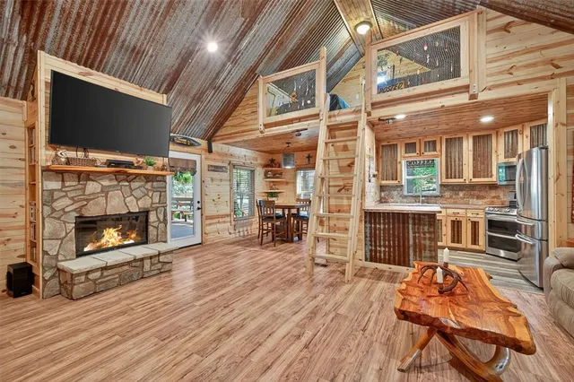 a living room with furniture a flat screen tv and a fireplace