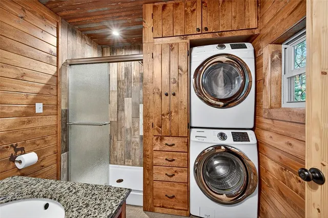 a bathroom with a sink a washer and dryer