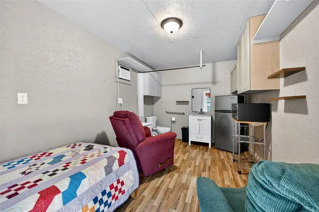 a bedroom with furniture and a flat screen tv