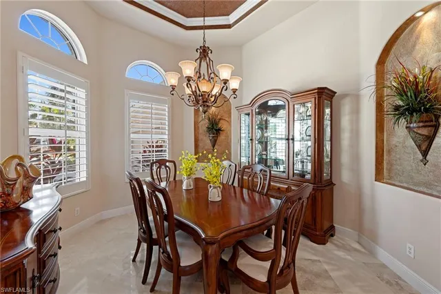 a view of a dining room with furniture and chandelier