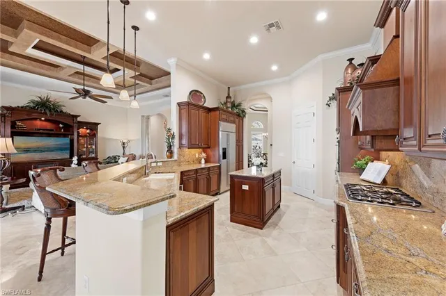a kitchen with stainless steel appliances granite countertop a sink a stove and a refrigerator