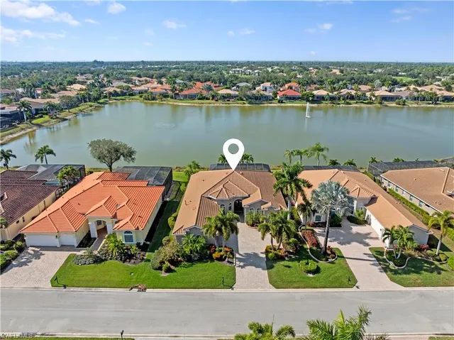 an aerial view of a house with outdoor space and lake view
