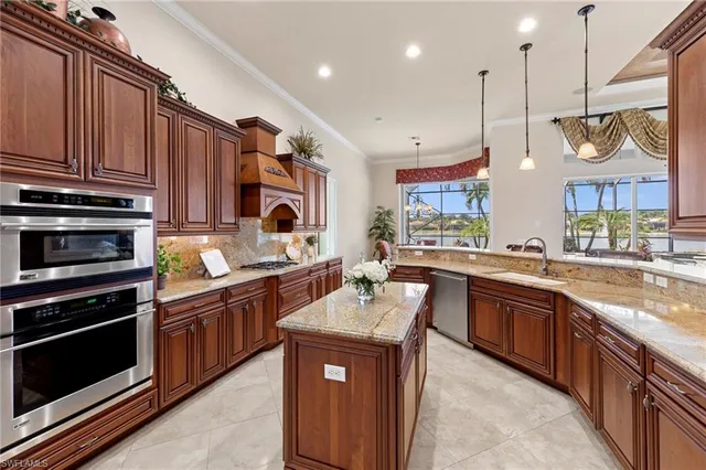 a kitchen with stainless steel appliances granite countertop wooden cabinets sink and stove