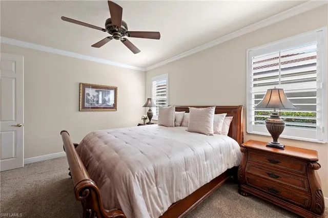 a bedroom with a bed a window and a chandelier