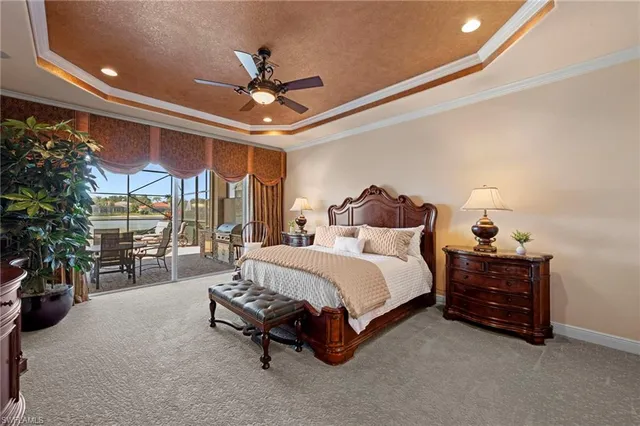 a spacious bedroom with a bed and a chandelier