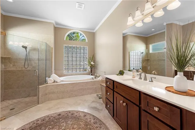 a spacious bathroom with a double vanity sink a large mirror and a bathtub