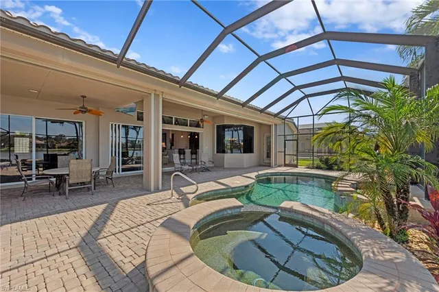 a living room with patio furniture and a potted plant